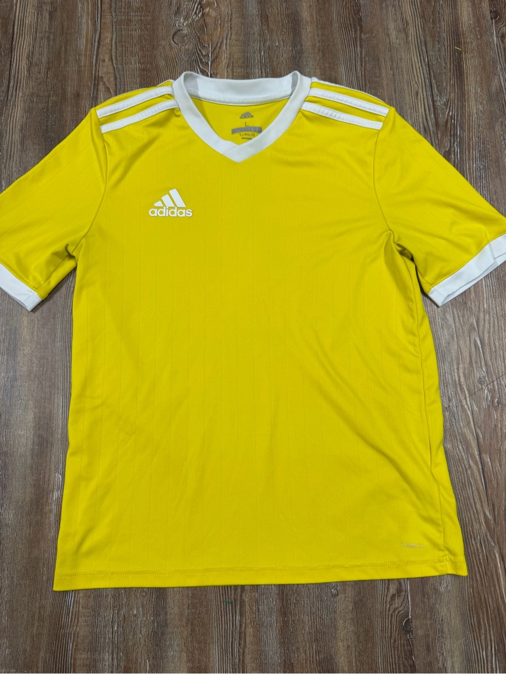 Adidas yellow shirt with white stripes on shoulders and sleeves, size L fits lik